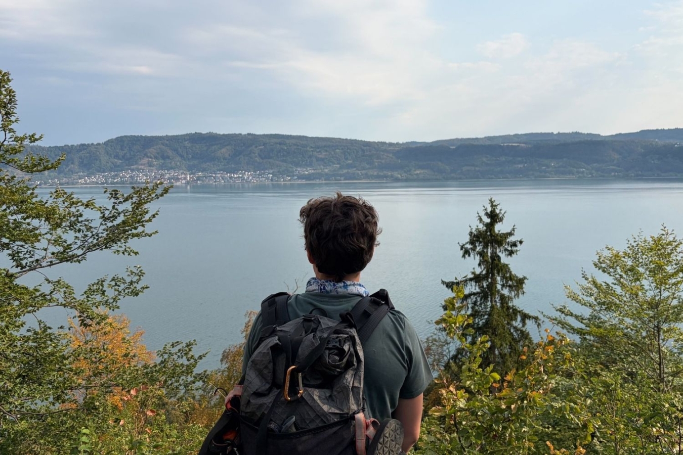 rear view of person overlooking lake