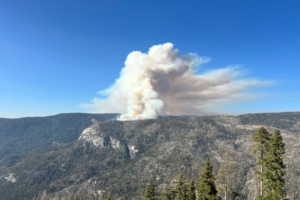 smoke rises over mountain