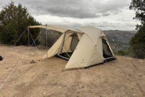 Alpha Breeze tent with the front awning extended and sleeping gear visible inside