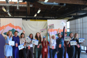 Pitchfest finalists celebrate together while holding awards
