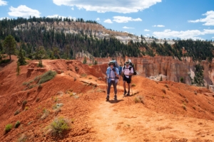 two hikers on red clay trail