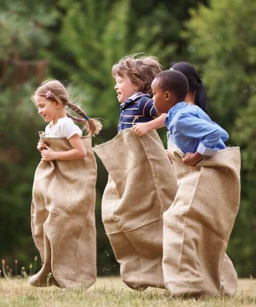 Children playing a racing game and having fun outside after studying
