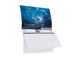 Wall calendar open to December with a blue ice cave photo