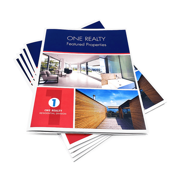 Magazines Printing Stack of saddle-stitched ONE Realty featured properties booklets with home photos on the cover