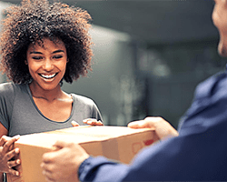 Rush critical overnight printing, courier handing a package to a customer