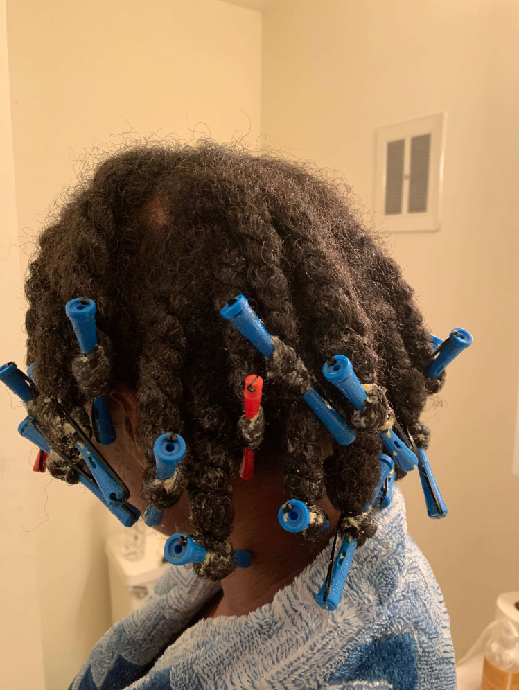 woman in a robe with perm rods in her hair