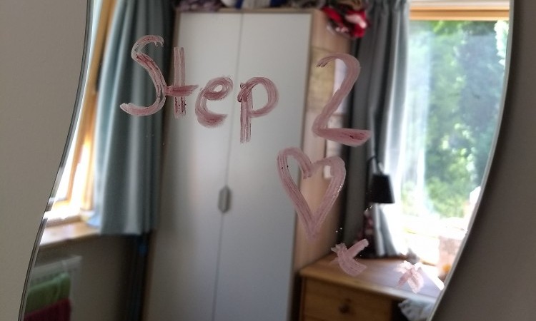 Lipstick on mirror which reads step 2