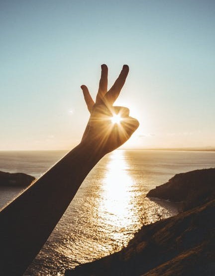 raised hand over the sunset raised hand over the sunset