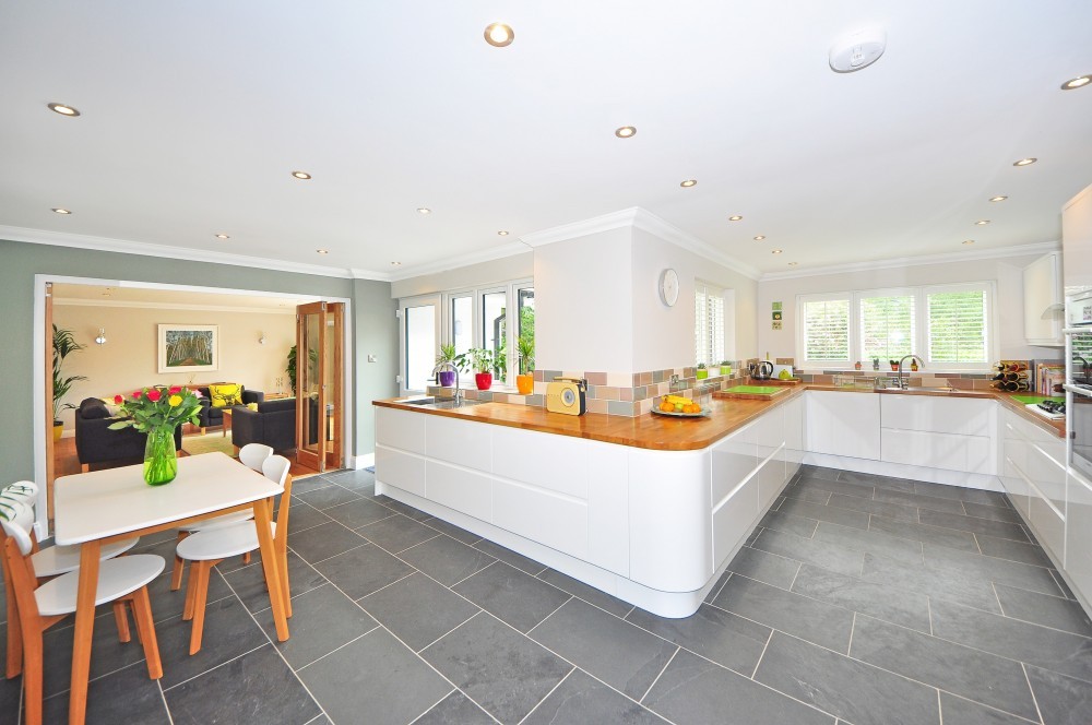 white kitchen with white table and four chairs