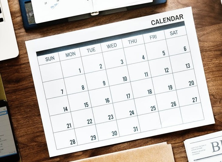 This is a calendar on a wooden desk.