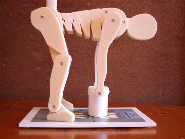 A Wooden Figurine Man Picking Up an Object