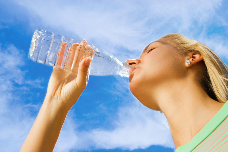A Woman Drinking a Bottle of Water