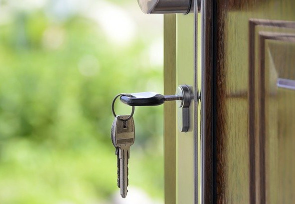 Key in the lock of an open door