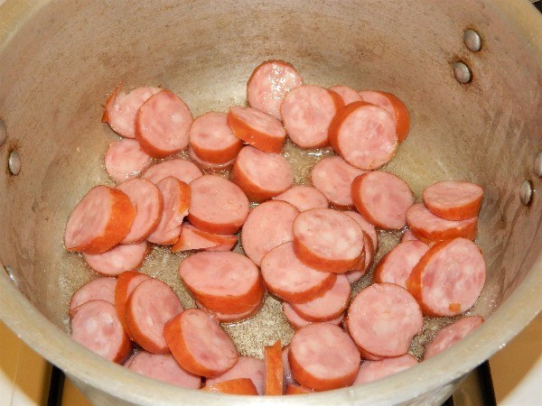 Frying sliced smoked sausage Smoked Sausage Potato Soup-Frying Sliced Smoked Sausage