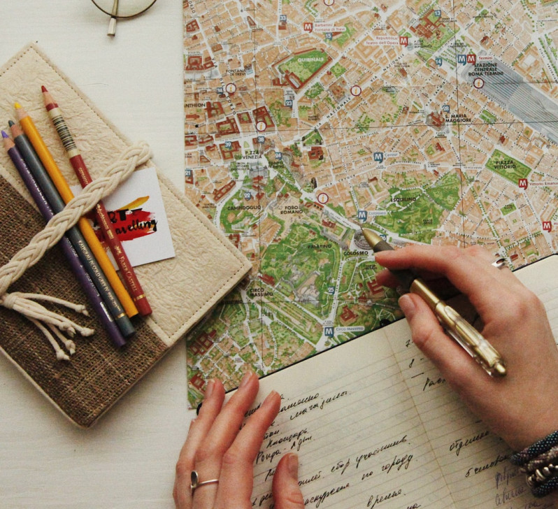 Planning a holiday budget with travel notes and a calculator