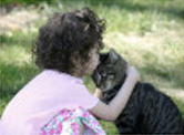Child kisses her cat
