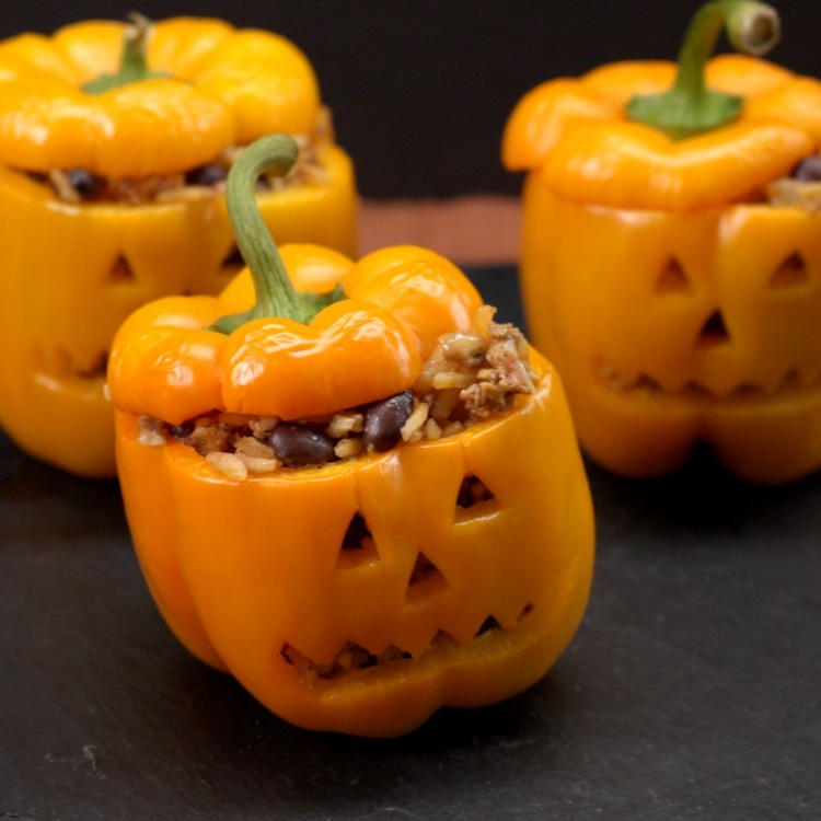 Stuffed orange peppers cut to look like jack-o'-lanterns