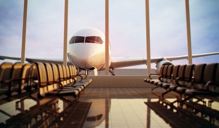 Photo of plane at airport terminal.