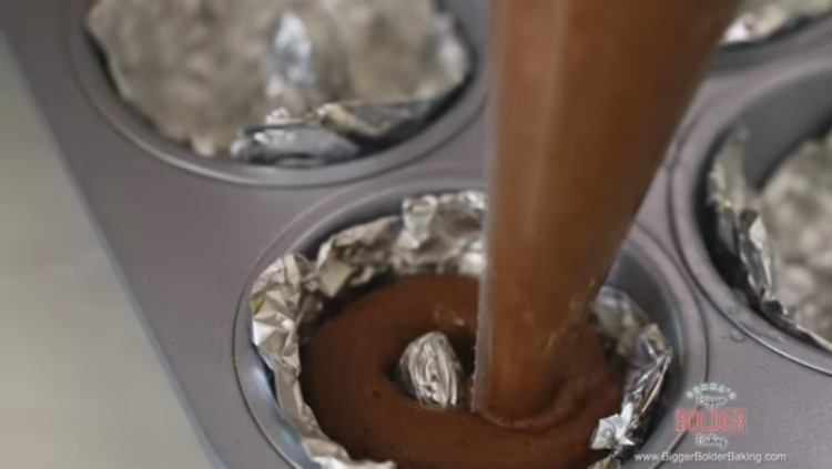 Filling DIY doughnut tin with chocolate cake doughnut batter