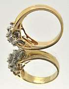 LADIES 14 KT GOLD AND DIAMOND CLUSTER RING.