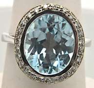 LADIES 14 KT WHITE GOLD BLUE TOPAZ AND DIAMOND RING.