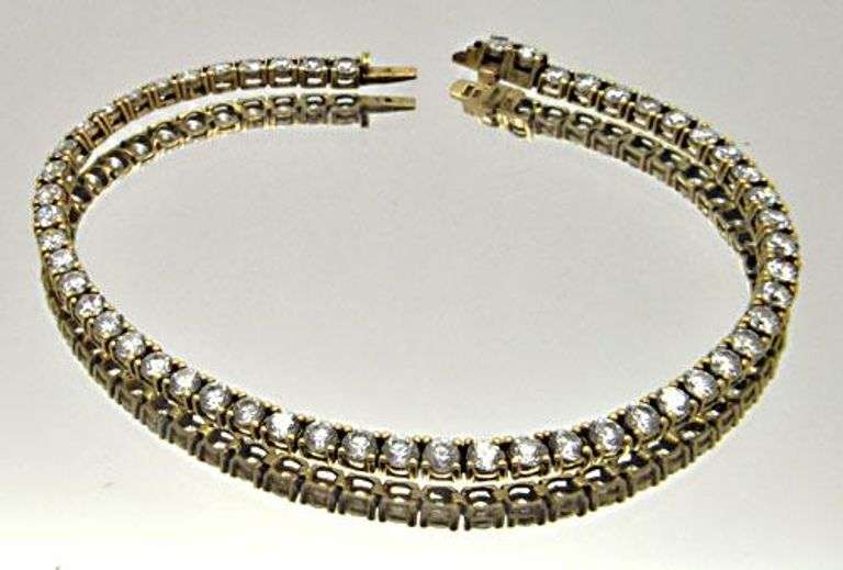 LADIES 14 KT YELLOW GOLD TENNIS BRACELET.