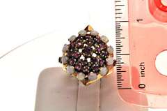 18K YELLOW GOLD OPAL AND RUBY ROUND PYRAMIDE RING.