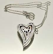 14KT GOLD HEART PENDANT/W WHITE AND CHOCOLATE DIAMONDS.