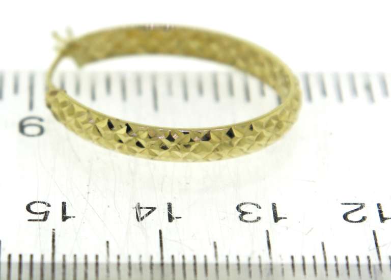 Simple Yellow Gold Diamond Cut Oval Hoop Earrings