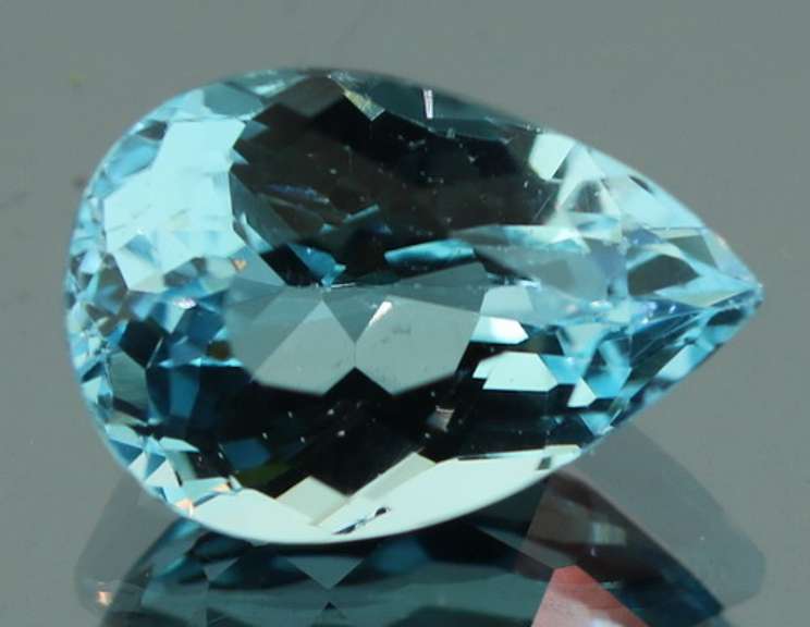 Very vivid 7.23ct pear cut Topaz center stone