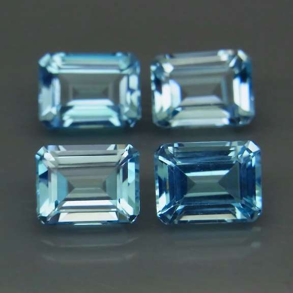Large 10.95ct vivid blue emerald cut Topaz set