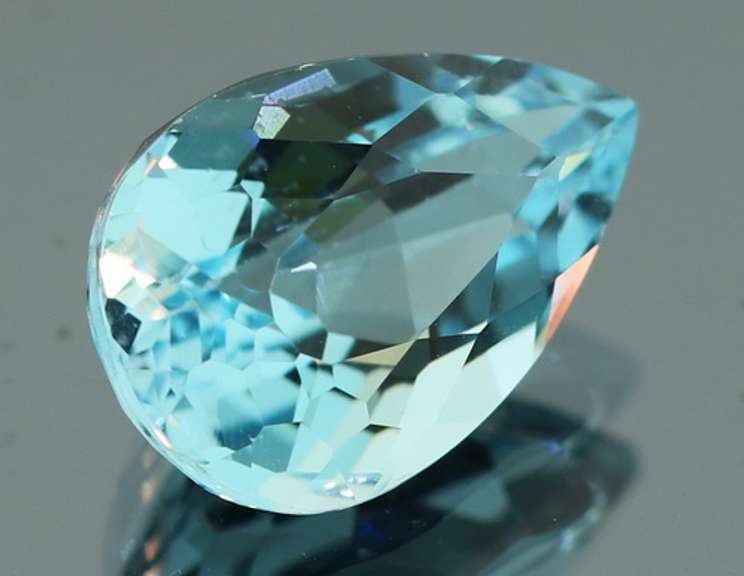 Very vivid 7.23ct pear cut Topaz center stone