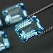 Large 10.95ct vivid blue emerald cut Topaz set