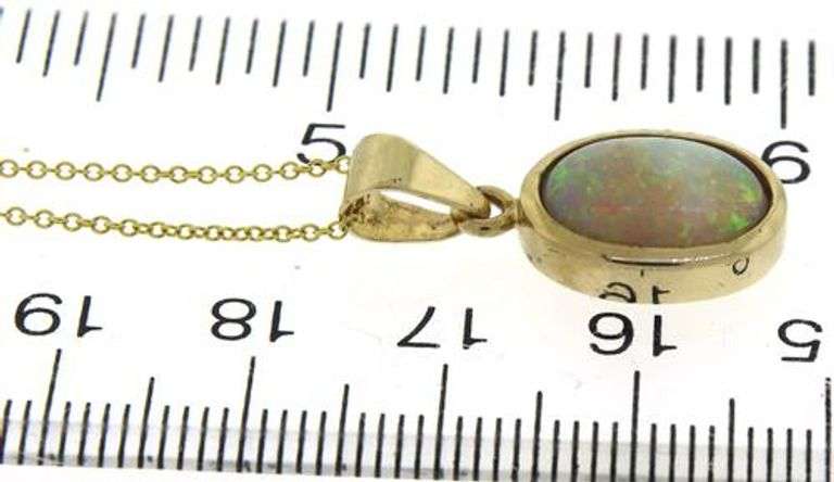 Great Bezel Set Oval Opal Necklace in yellow Gold
