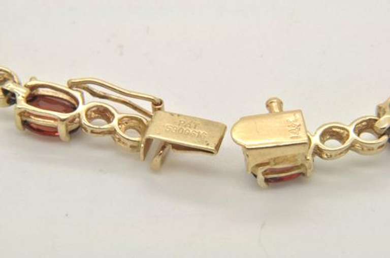 LADIES 14 KT GOLD GARNET BRACELET