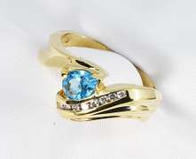 Feminine Pear Cut Blue Topaz and Diamond Ring in 14K