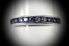 Desirable 18K White Gold Channel Set Sapphire Band