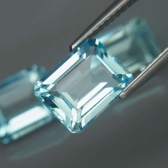 Eye clean 8.23ct vivid blue emerald cut Topaz set