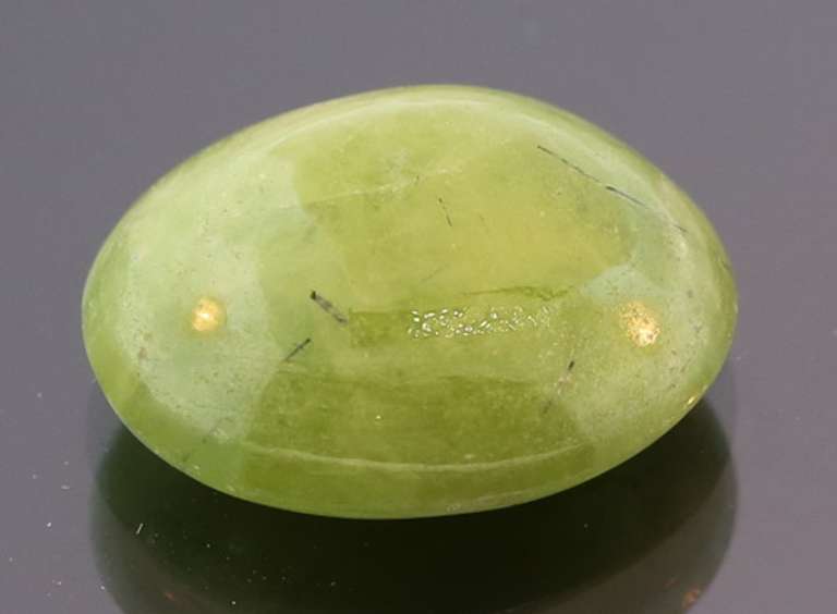 Mirror luster 9.44ct Sphene cabochon