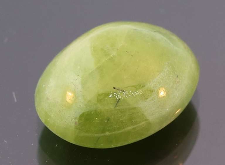 Mirror luster 9.44ct Sphene cabochon