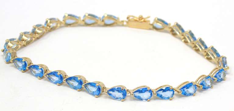 Gorgeous Pear Blue Topaz Line Yellow Gold Bracelet