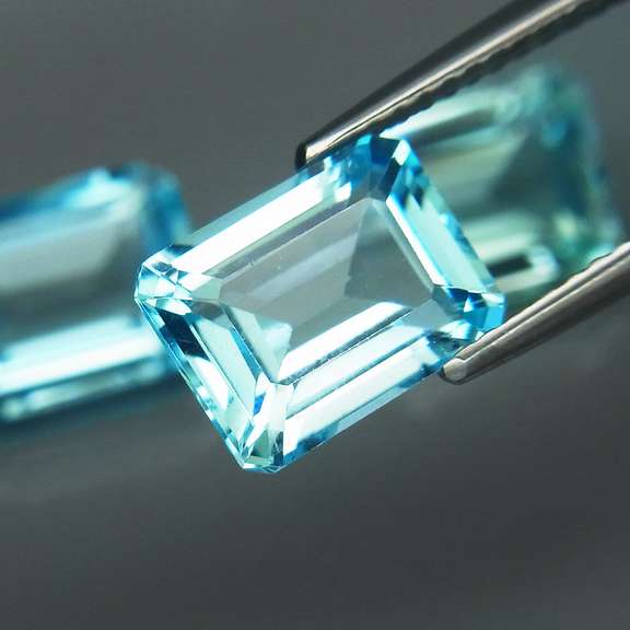 Eye clean 8.25ct vivid blue emerald cut Topaz set
