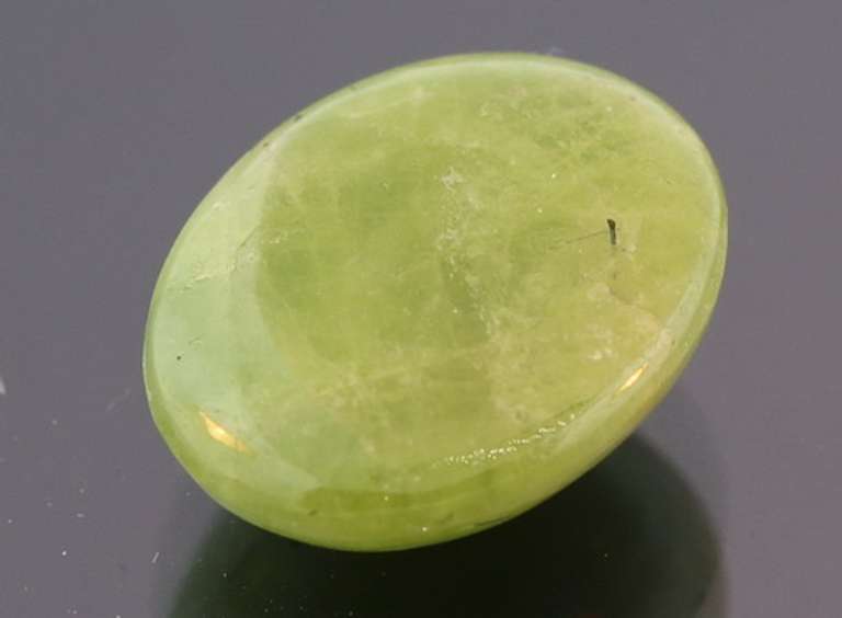 Mirror luster 9.44ct Sphene cabochon