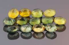 Glittering 6.69ct green and gold Sapphire set