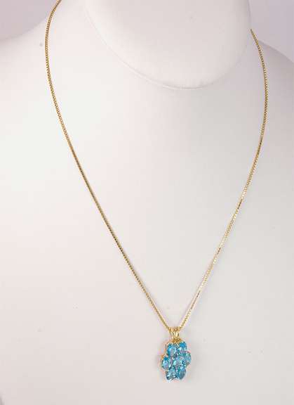 Seven Beautiful Blue Topaz Stones Set in a 14k Gold Pendant Looped with A 14k Gold Box Chain