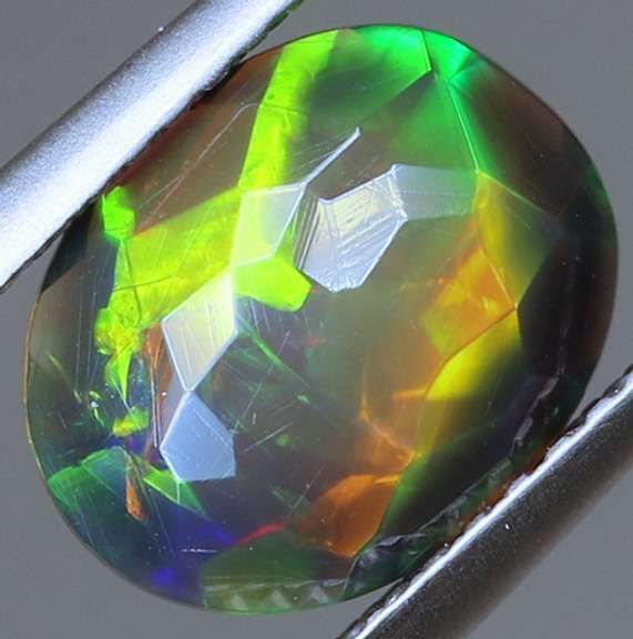 Fully faceted full panel flashing 1.45ct oval cut Black Opal