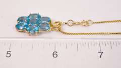 Seven Beautiful Blue Topaz Stones Set in a 14k Gold Pendant Looped with A 14k Gold Box Chain
