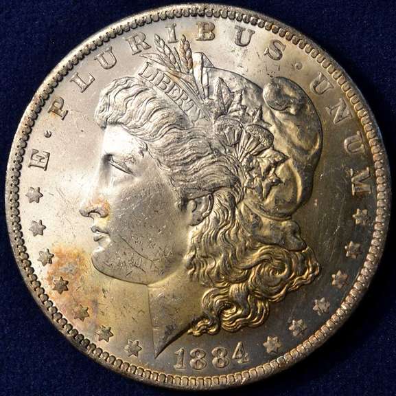 1884-O Morgan Silver Dollar, BU. Orange/Yellow Toning.