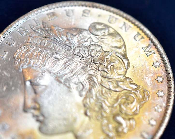 1884-O Morgan Silver Dollar, BU. Orange/Yellow Toning.
