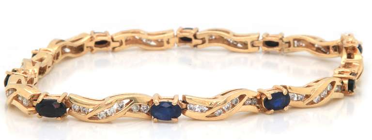 LADIES 14 KT YELLOW GOLD DIAMOND AND SAPPHIRE BRACELET.